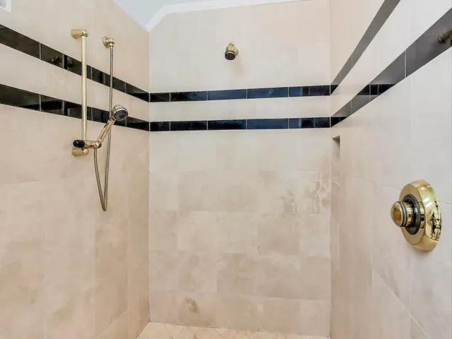 a bathroom with a shower and a shower