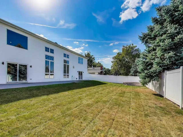 a swimming pool with outdoor seating and yard