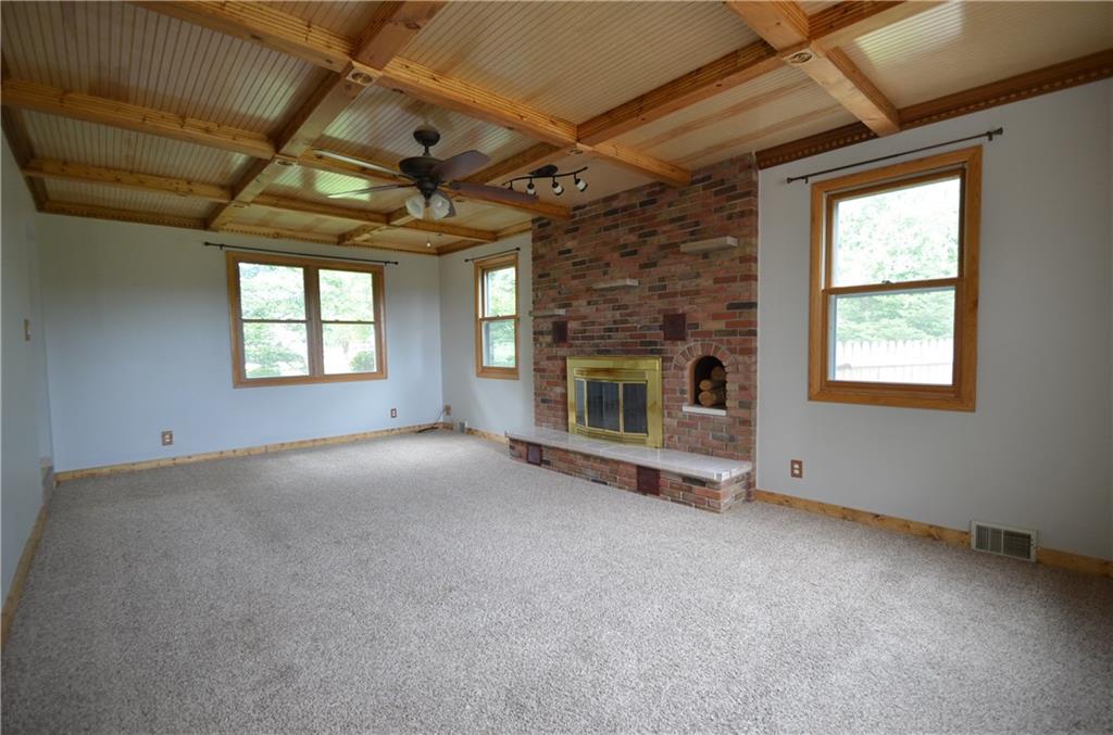 141 Youkers Road Butler, PA 16001 - Photo 2 of 25 Spacious family room has windows on 3 sides, natural wood ceiling & trim & raised hearth brick fireplace