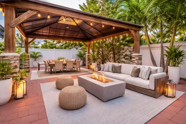 a outdoor living space with patio furniture and a umbrella