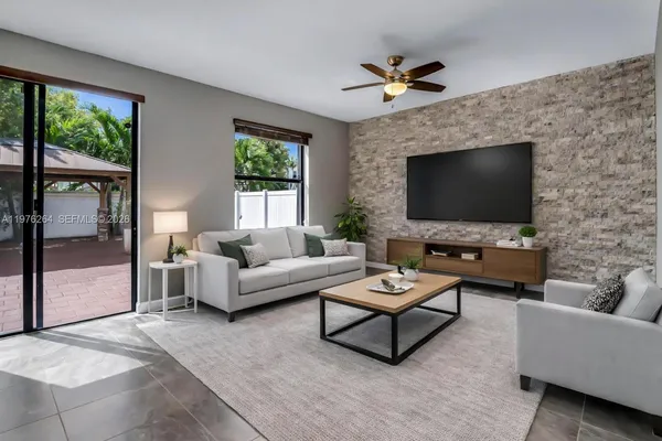 a kitchen with stainless steel appliances granite countertop a sink a stove a refrigerator a counter top space and cabinets
