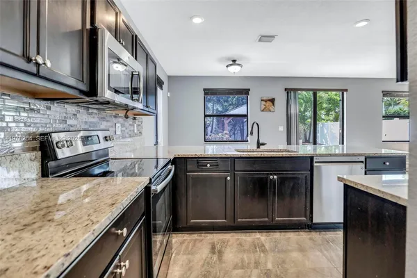 a view of a room with wooden floor and fan