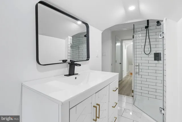 a bathroom with a sink vanity and a mirror