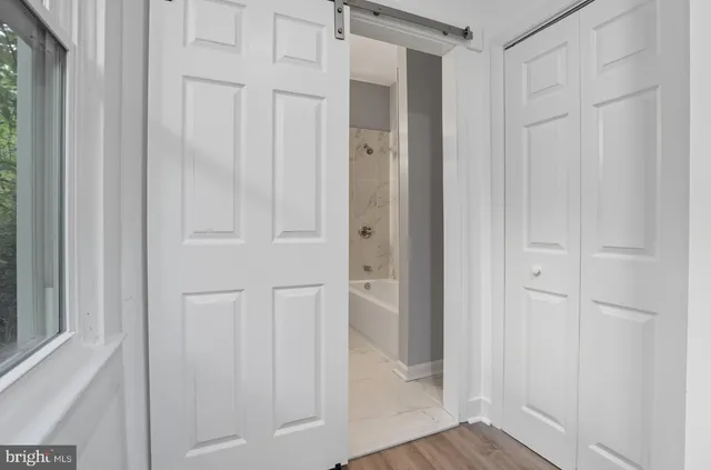 a view of a hallway with wooden floor