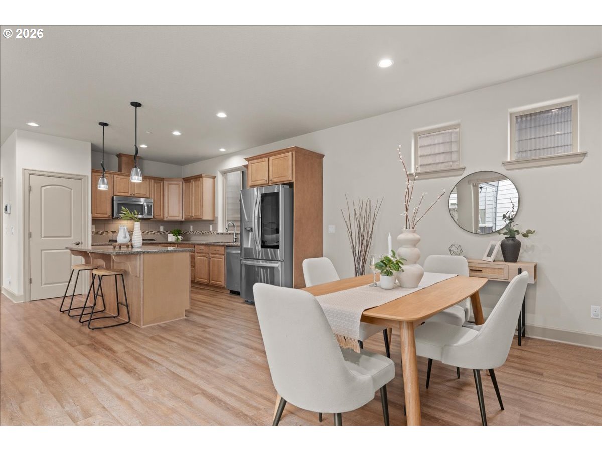 10899 Southwest Barber Street Wilsonville, OR 97070 - Photo 12 of 44 a view of a dining room with furniture and wooden floor