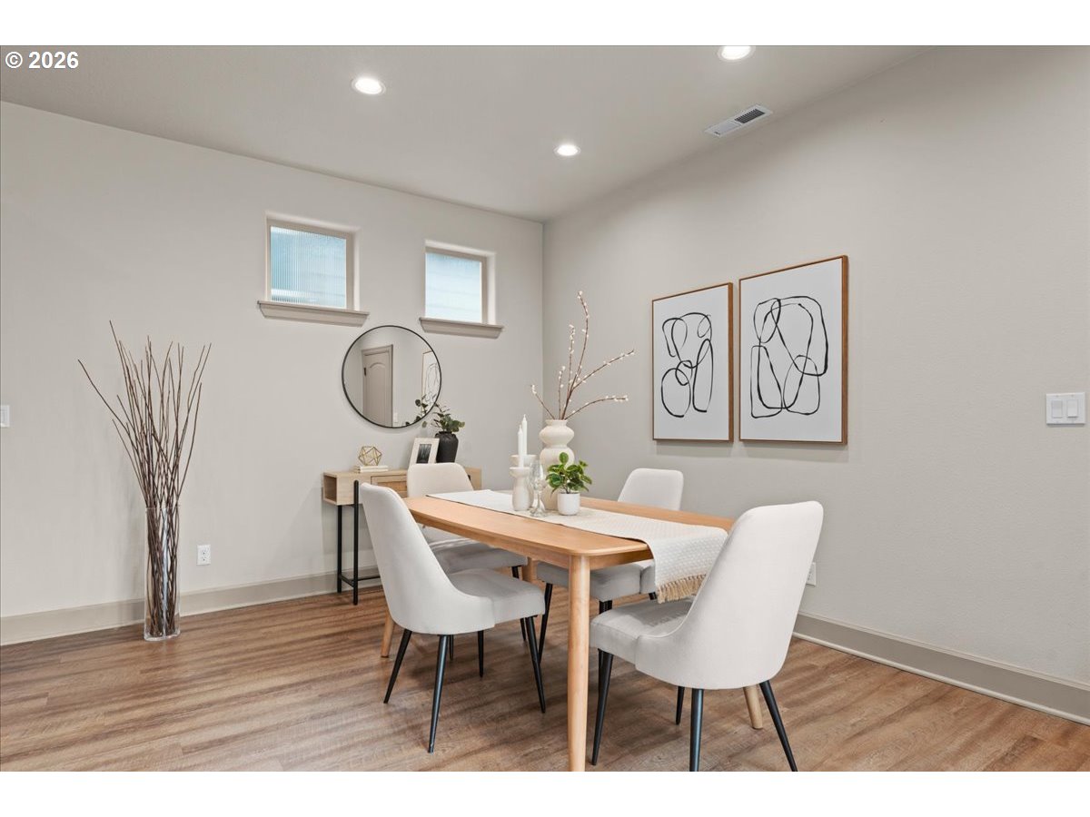 10899 Southwest Barber Street Wilsonville, OR 97070 - Photo 13 of 44 a view of a dining room with furniture and wooden floor