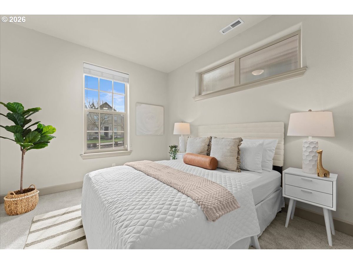 10899 Southwest Barber Street Wilsonville, OR 97070 - Photo 14 of 44 a bedroom with a bed and a potted plant