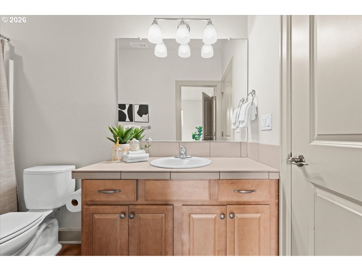 10899 Southwest Barber Street Wilsonville, OR 97070 - Photo 16 of 44 a bathroom with a sink vanity and a mirror