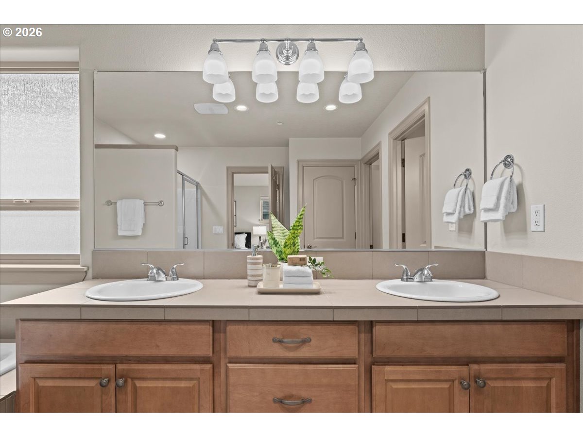10899 Southwest Barber Street Wilsonville, OR 97070 - Photo 22 of 44 a bathroom with a sink and a mirror