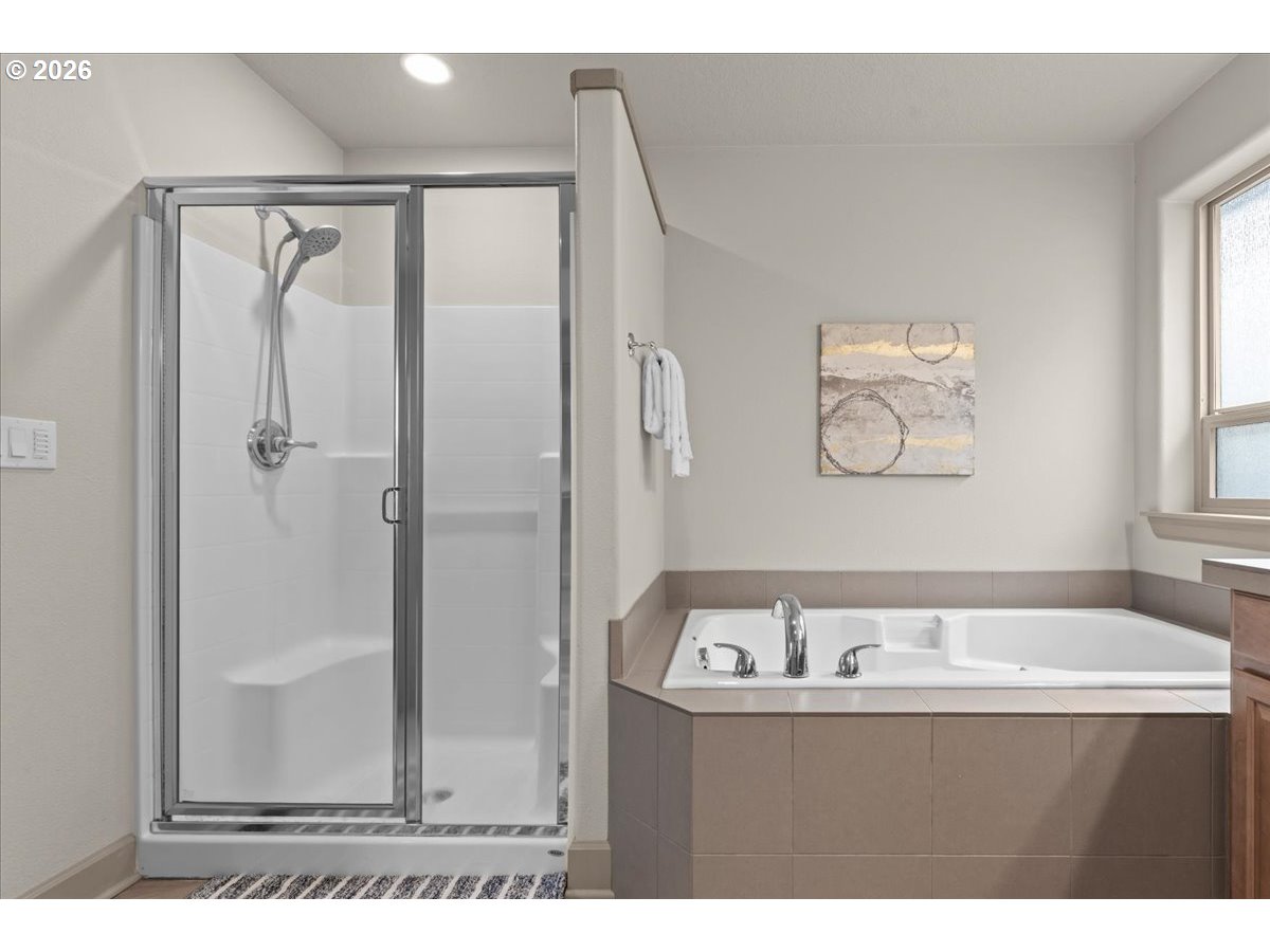 10899 Southwest Barber Street Wilsonville, OR 97070 - Photo 23 of 44 a bathroom with a tub sink and mirror