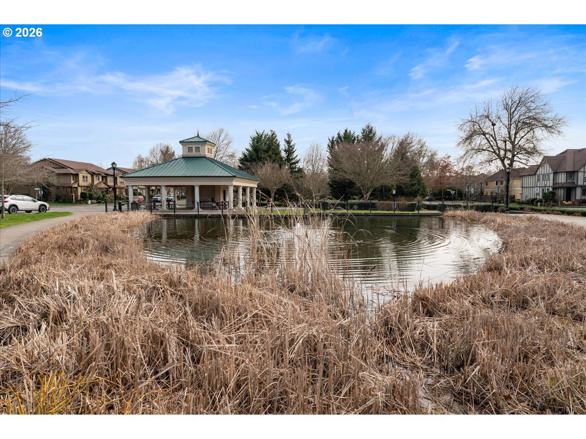 10899 Southwest Barber Street Wilsonville, OR 97070 - Photo 43 of 44 a view of a lake with houses in the back