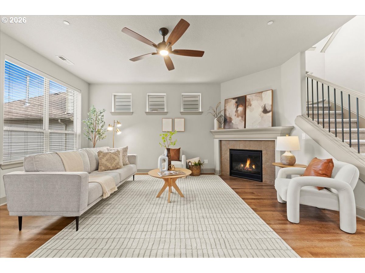 10899 Southwest Barber Street Wilsonville, OR 97070 - Photo 6 of 44 a living room with furniture and a fireplace