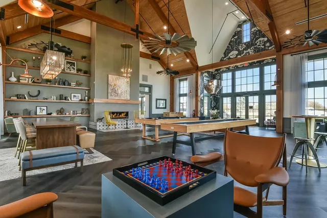 a living room with furniture a rug and a chandelier