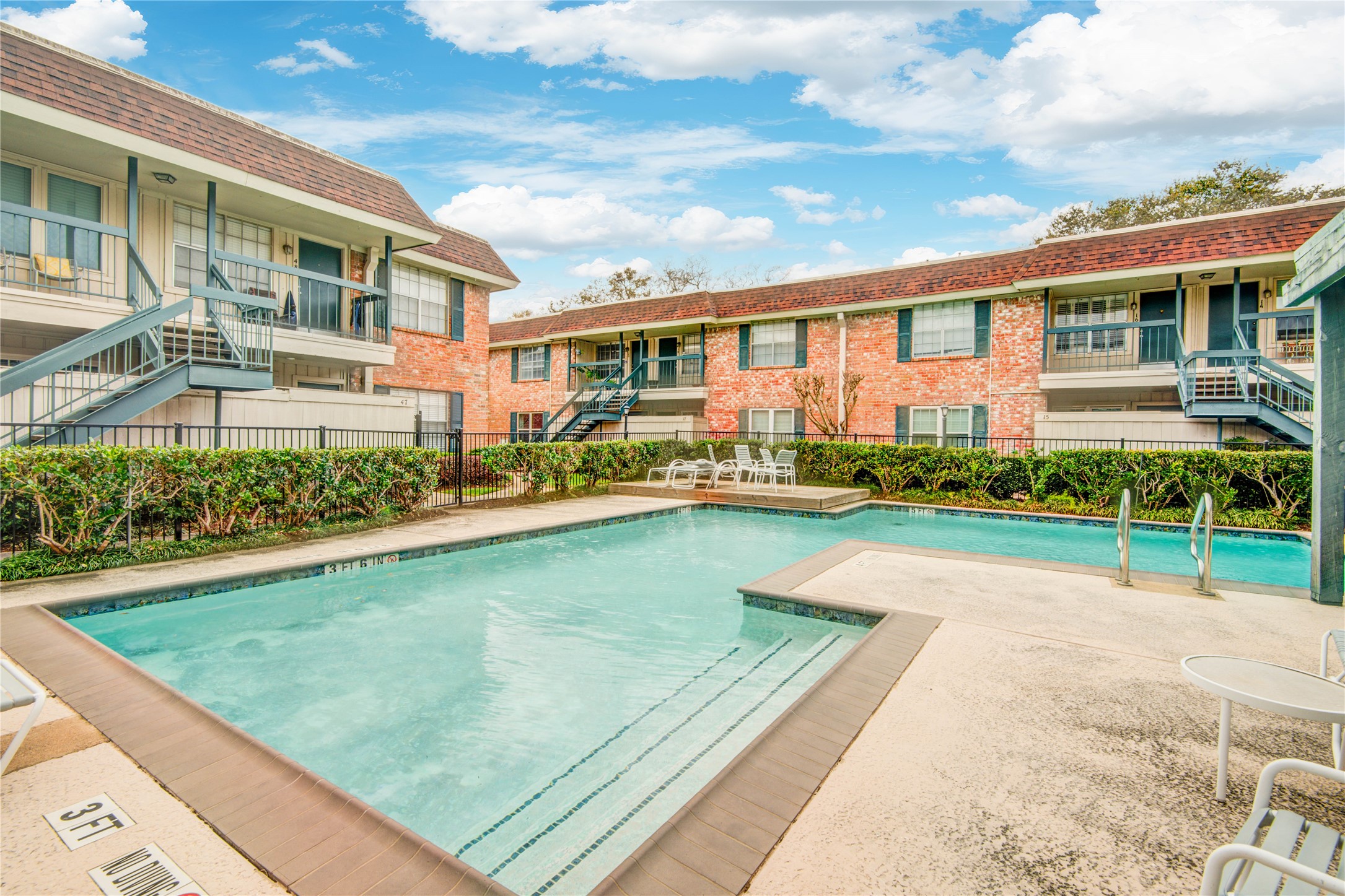 a view of swimming pool with outdoor seating and a garden