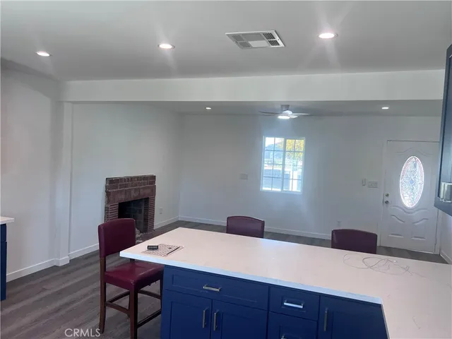 a room with a table chairs and a wooden floor