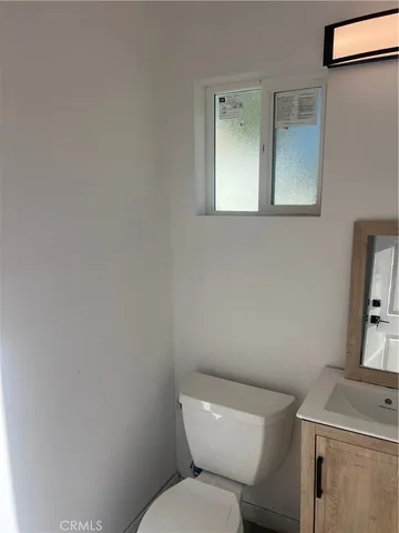 a white toilet sitting next to a bathroom sink