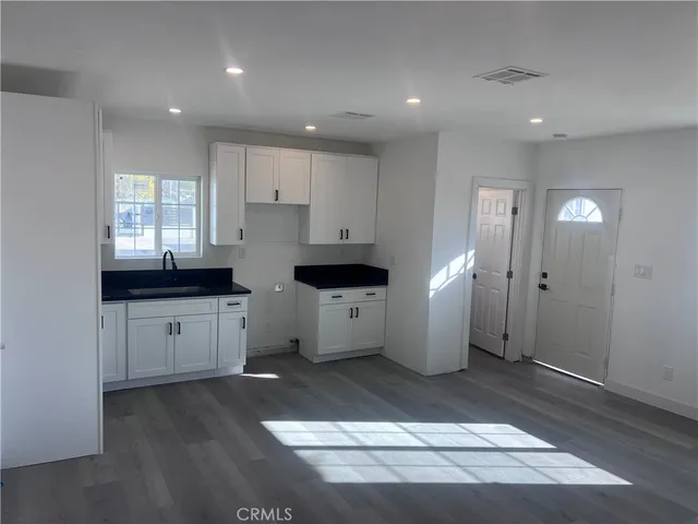 a kitchen with a sink and refrigerator