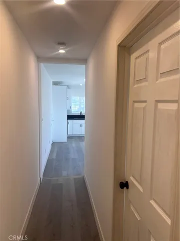 a view of a hallway with a wooden cabinets