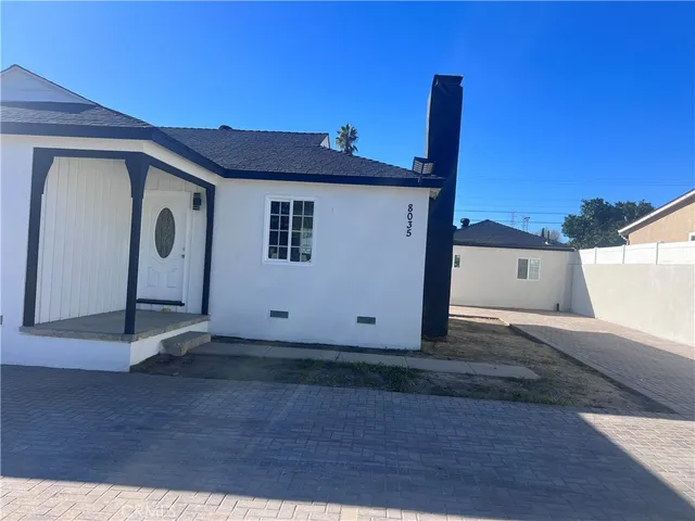 a view of a house with wooden fence