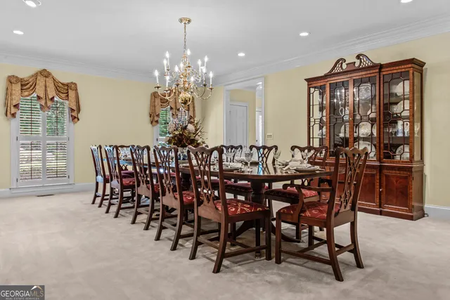 a view of a dining room with furniture and chandelier