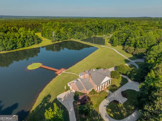 an aerial view of a house with a lake view