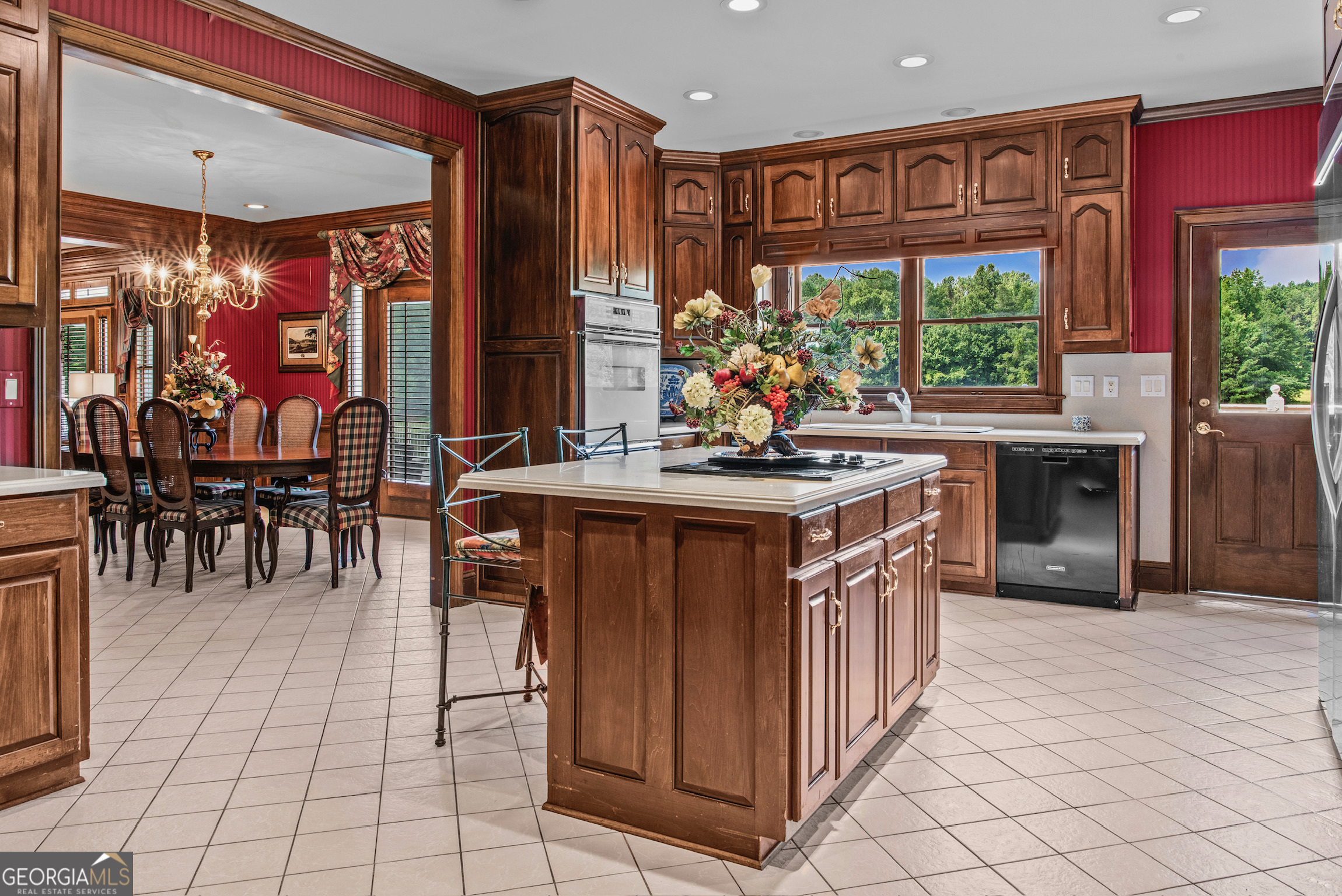 2720 Doster Road Madison, GA 30650 - Photo 23 of 60 a kitchen with stainless steel appliances granite countertop a stove a sink and a microwave