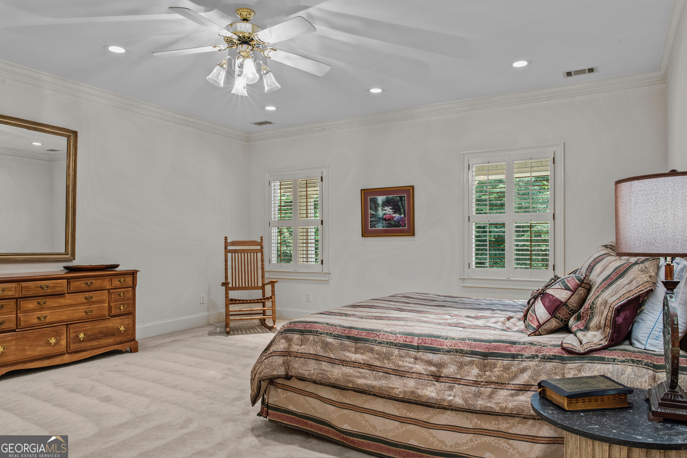 2720 Doster Road Madison, GA 30650 - Photo 39 of 60 a bedroom with a bed and a dresser with the shoe rack