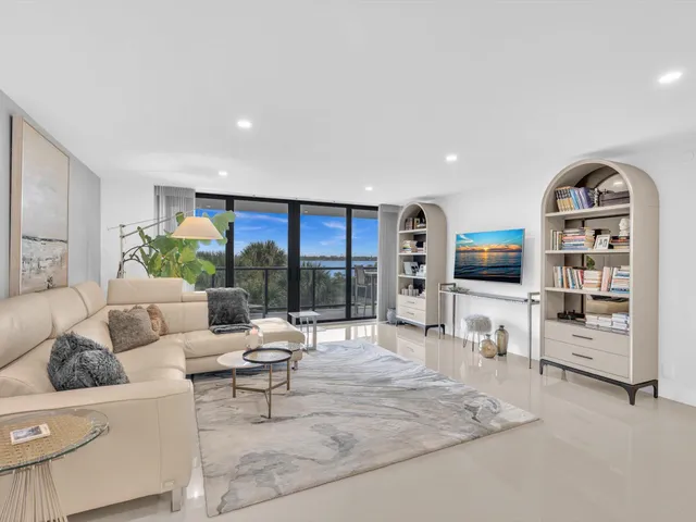 a view of a porch with chairs and potted plants
