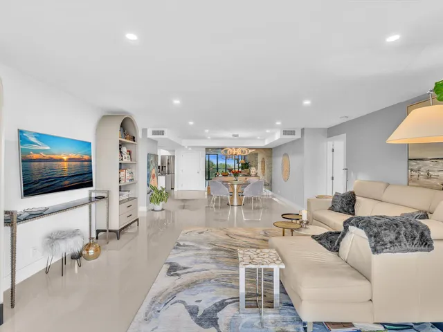 a bed sitting in a spacious bedroom next to a window