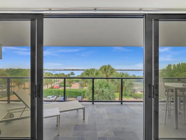 a bedroom with a bed a fireplace and a potted plant