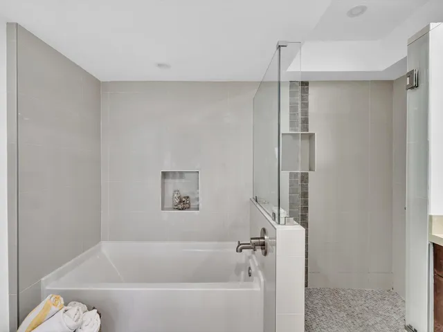 a view of a swimming pool with a table and chairs potted plants
