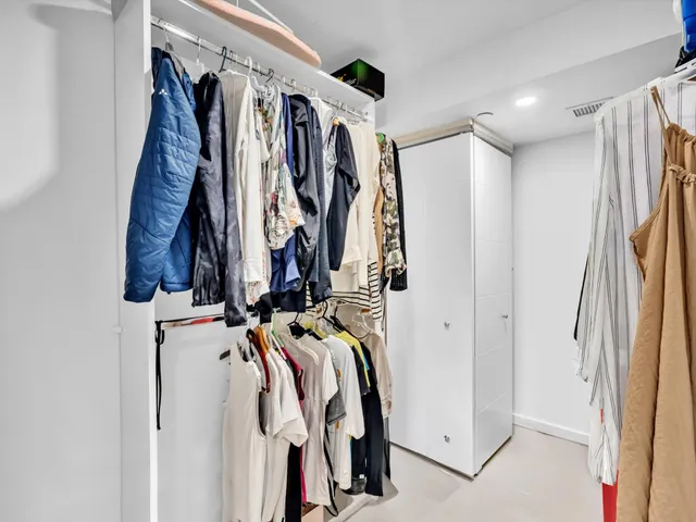 a view of a patio with a table and chairs under an umbrella next to a yard