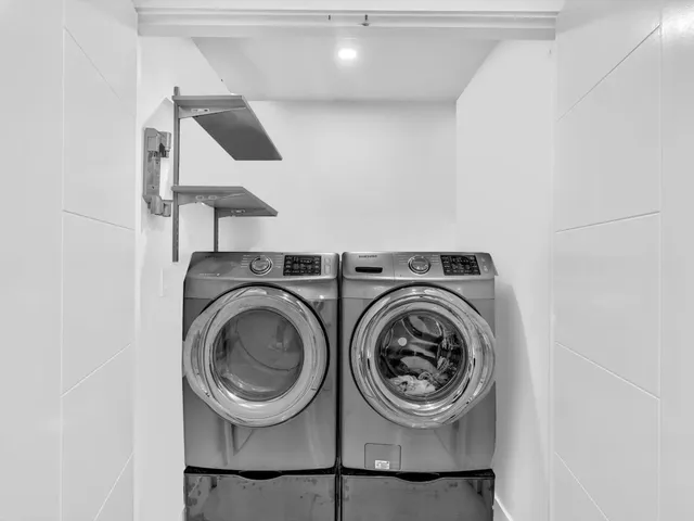 a view of living room filled with furniture and white walls