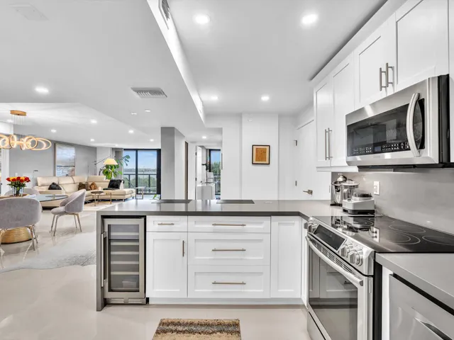 a view of a dining room and livingroom with furniture wooden floor and a rug