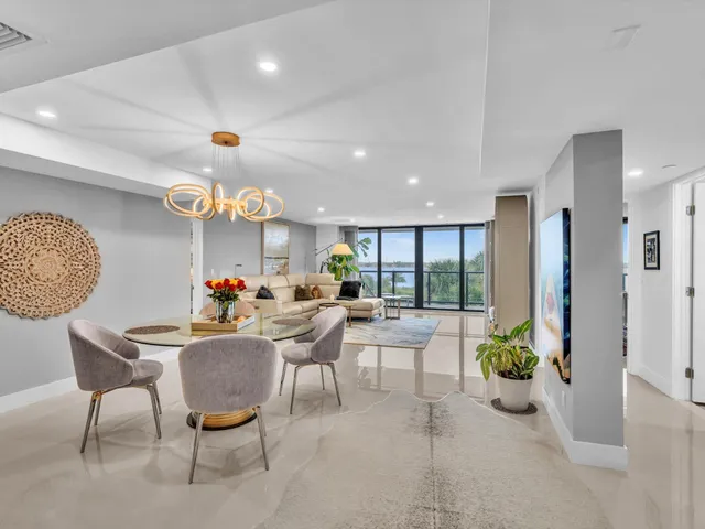 a living room with furniture potted plant and a chandelier