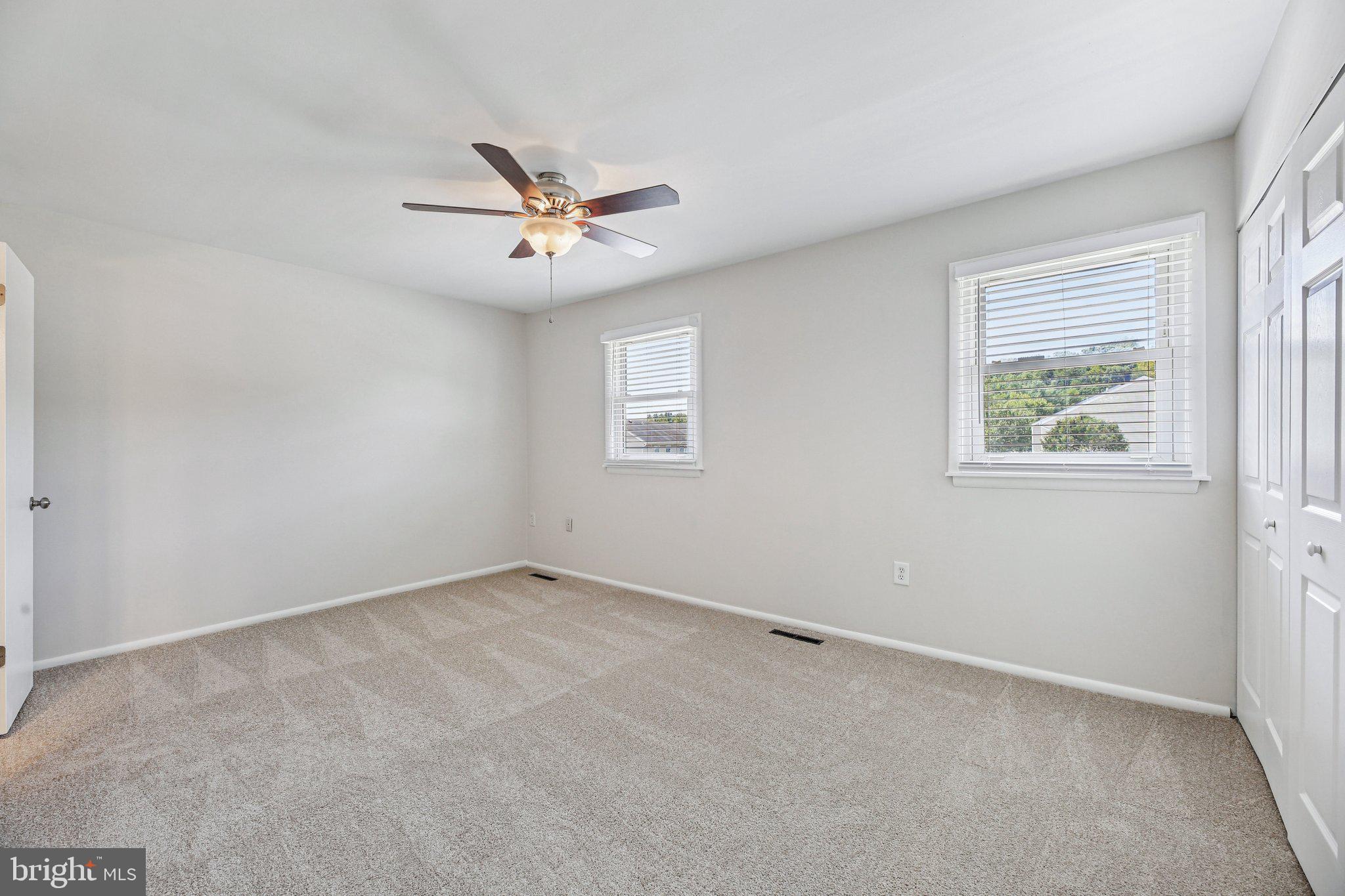 5603 Selford Road Baltimore, MD 21227 - Photo 16 of 31 an empty room with a window and a fan