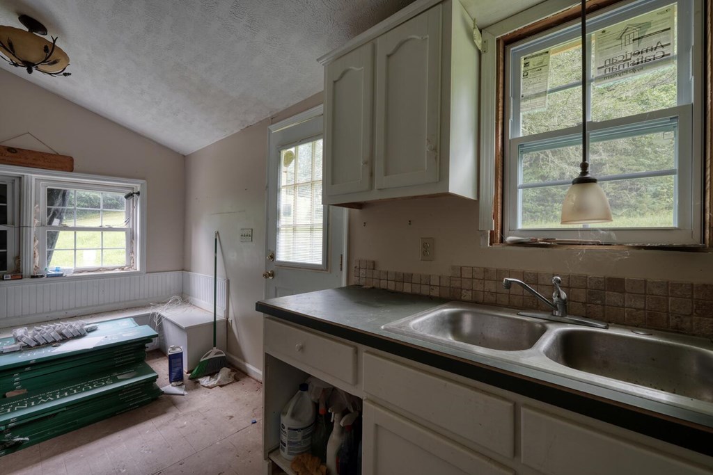 580 Emmaus Road Epworth, GA 30541 - Photo 17 of 33 a kitchen that has a sink and a stove
