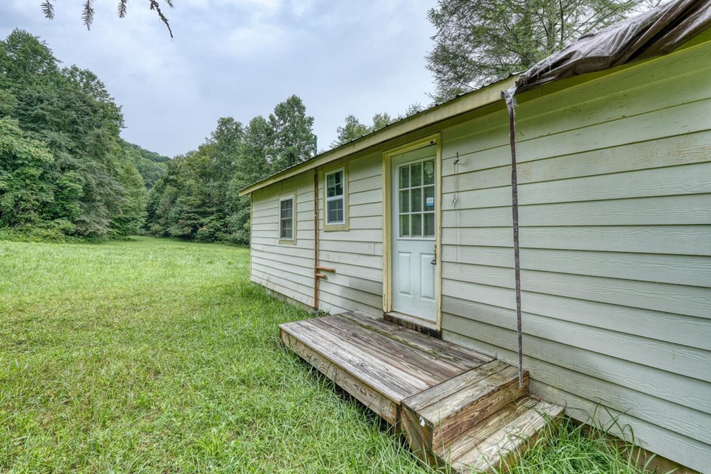 580 Emmaus Road Epworth, GA 30541 - Photo 29 of 33 a view of a backyard with a chair and potted plants