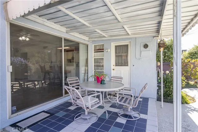 a view of a dining room with furniture and front door