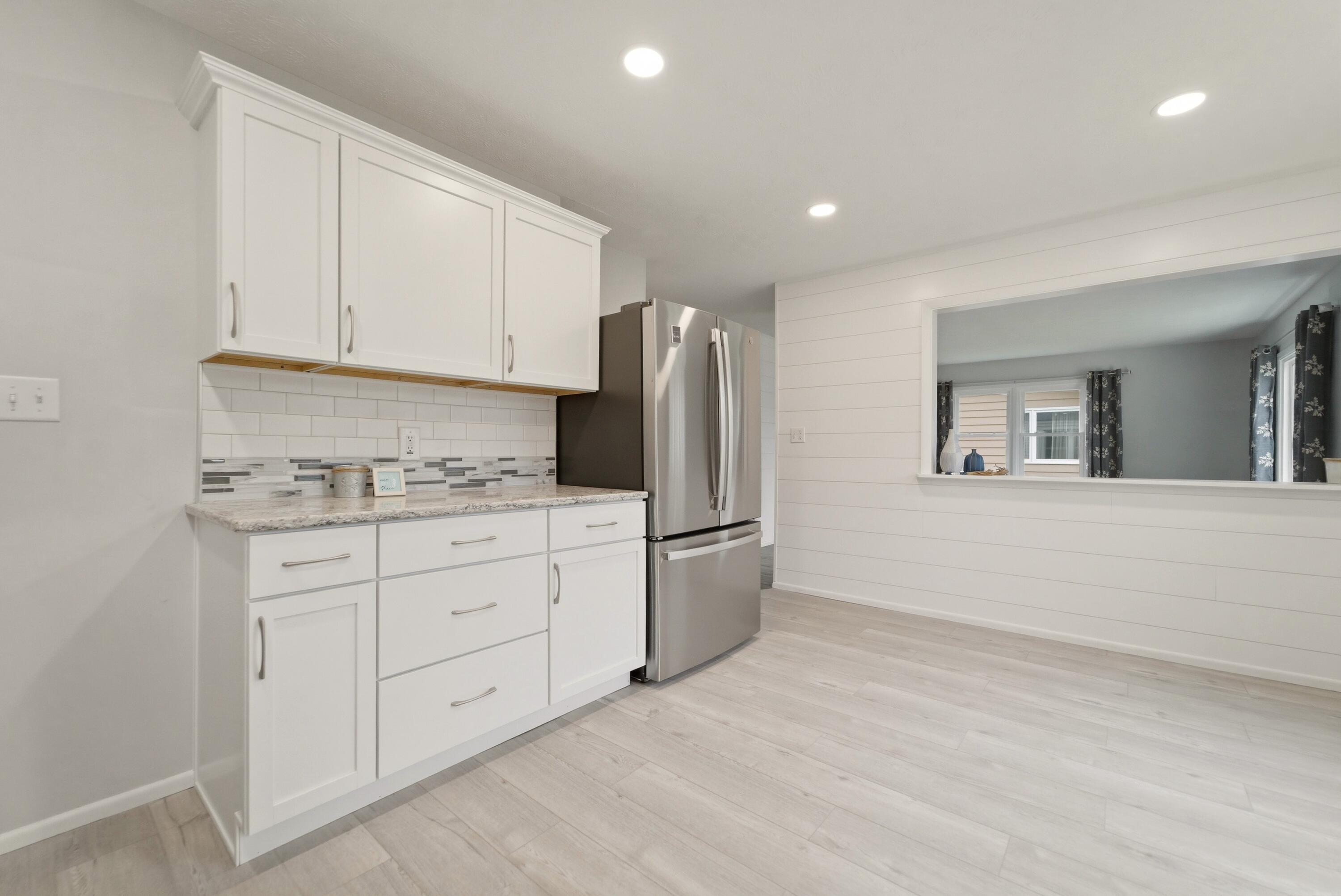 1208 Riley Court La Porte, IN 46350 - Photo 10 of 36 a kitchen with granite countertop white cabinets and stainless steel appliances