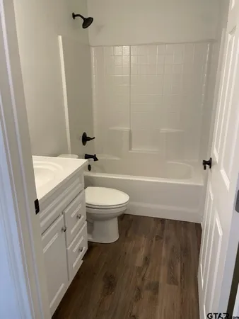 a bathroom with a toilet a sink and bathtub