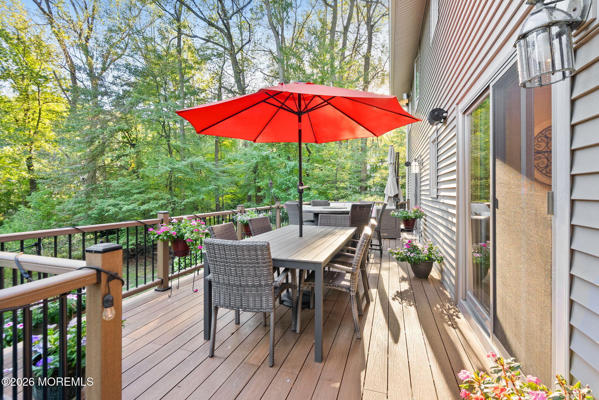 21 Stoney Brook Road Holmdel, NJ 07733 - Photo 15 of 40 a view of balcony with outdoor seating and wooden floor
