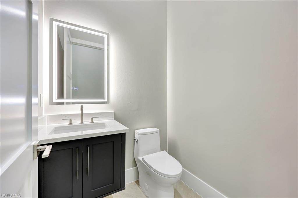 10493 Winterview Drive Naples, FL 34110 - Photo 15 of 40 a bathroom with a sink and a toilet