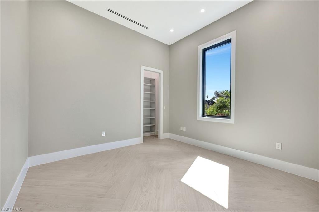 10493 Winterview Drive Naples, FL 34110 - Photo 24 of 40 an empty room with windows