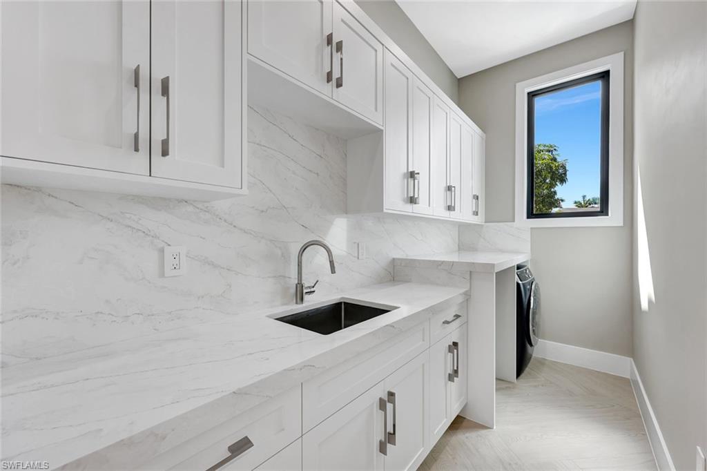 10493 Winterview Drive Naples, FL 34110 - Photo 25 of 40 a view with cabinets a sink and dishwasher