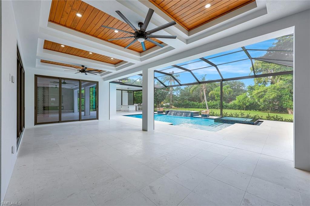 10493 Winterview Drive Naples, FL 34110 - Photo 30 of 40 a view of an empty room with a floor to ceiling windows and door