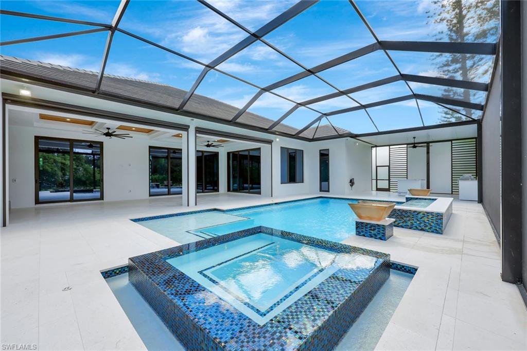 10493 Winterview Drive Naples, FL 34110 - Photo 34 of 40 a view of a house with pool table and chairs