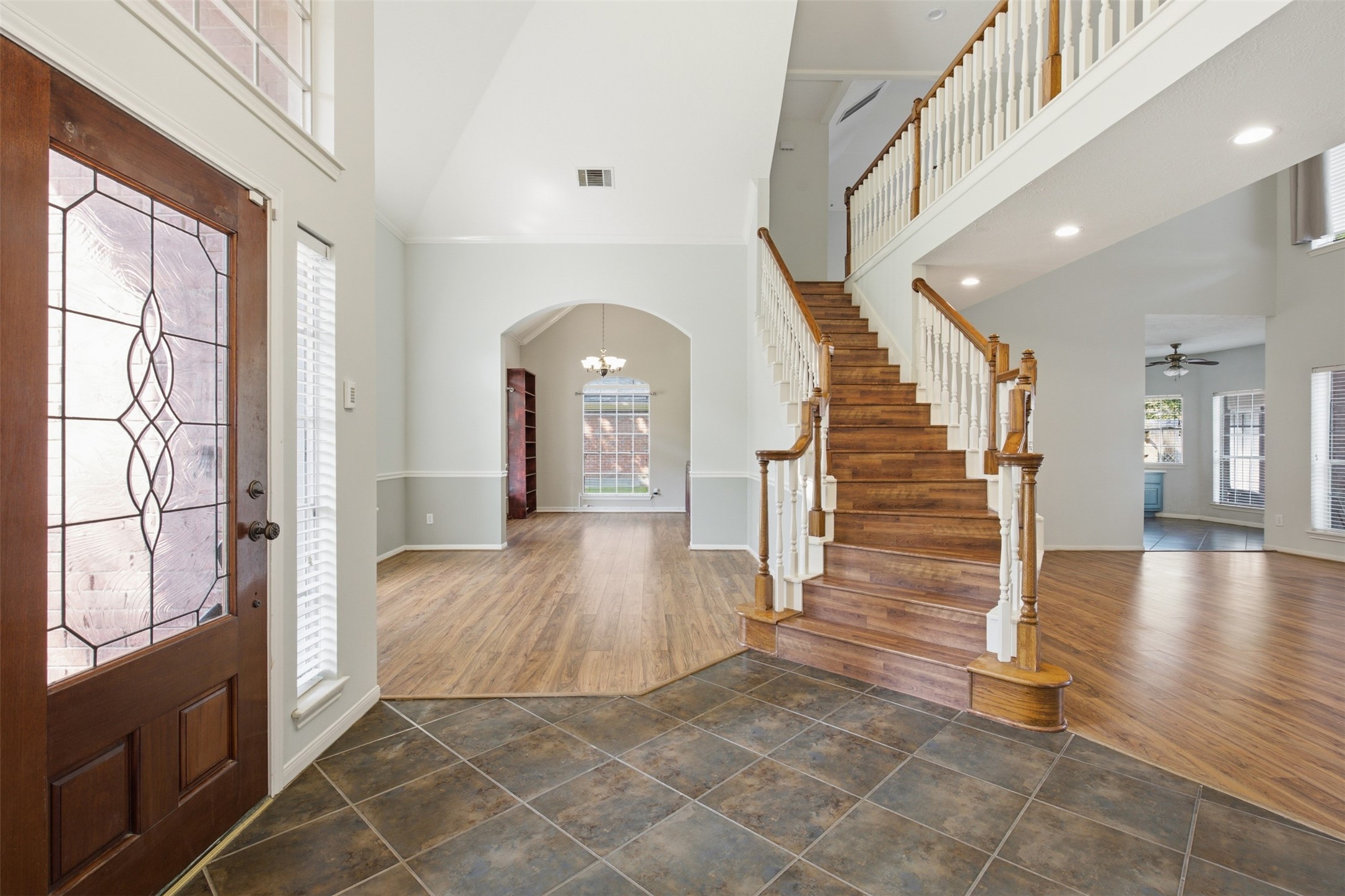 323 Magic Oaks Court Spring, TX 77388 - Photo 5 of 49 Another view of the two-story entry area with it's bright windows and natural light. Neutral paint and floors makes this home move-in ready!