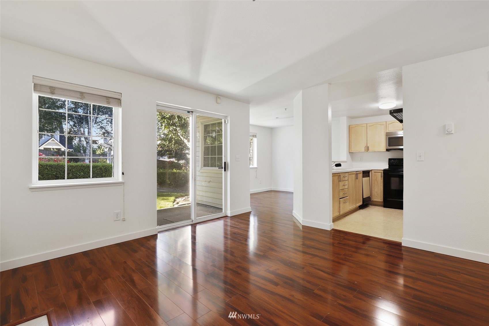 949 Aberdeen Avenue Northeast, Unit B104 Renton, WA 98056 - Photo 2 of 20 a view of an empty room with wooden floor and a window