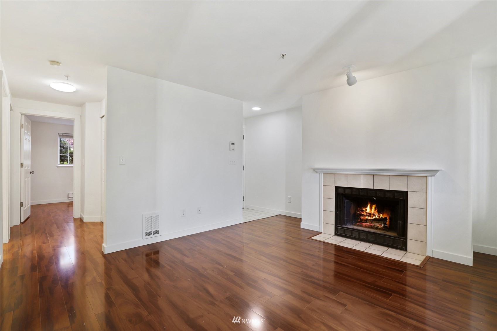 949 Aberdeen Avenue Northeast, Unit B104 Renton, WA 98056 - Photo 4 of 20 a view of an empty room with wooden floor and a fireplace
